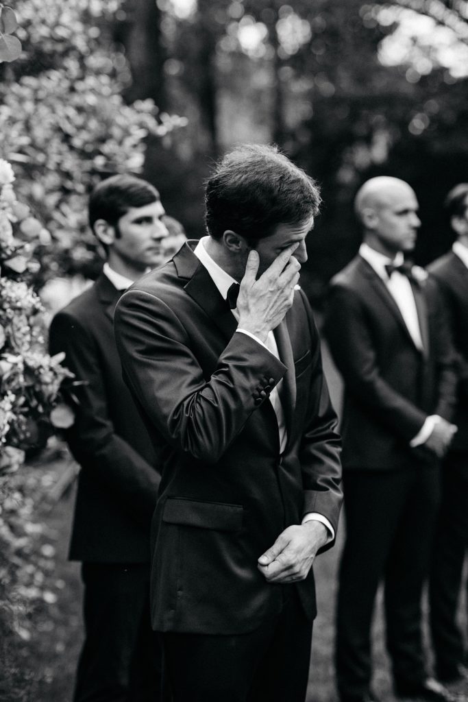 Groom tearing up watching Bride walk down the aisle at Houstonian wedding ceremony 