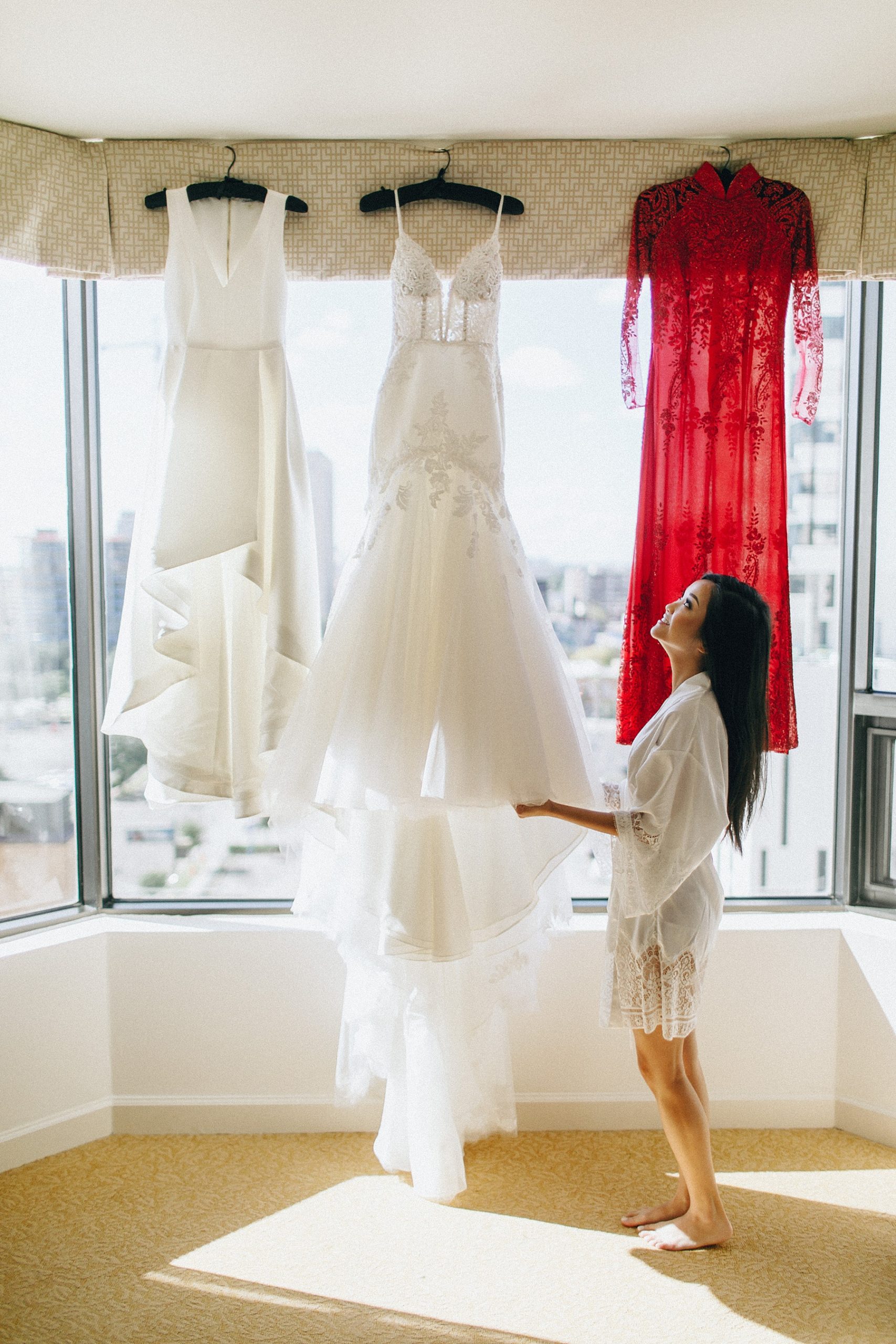 Bride admiring dress hung in window at the Four Seasons Houston 