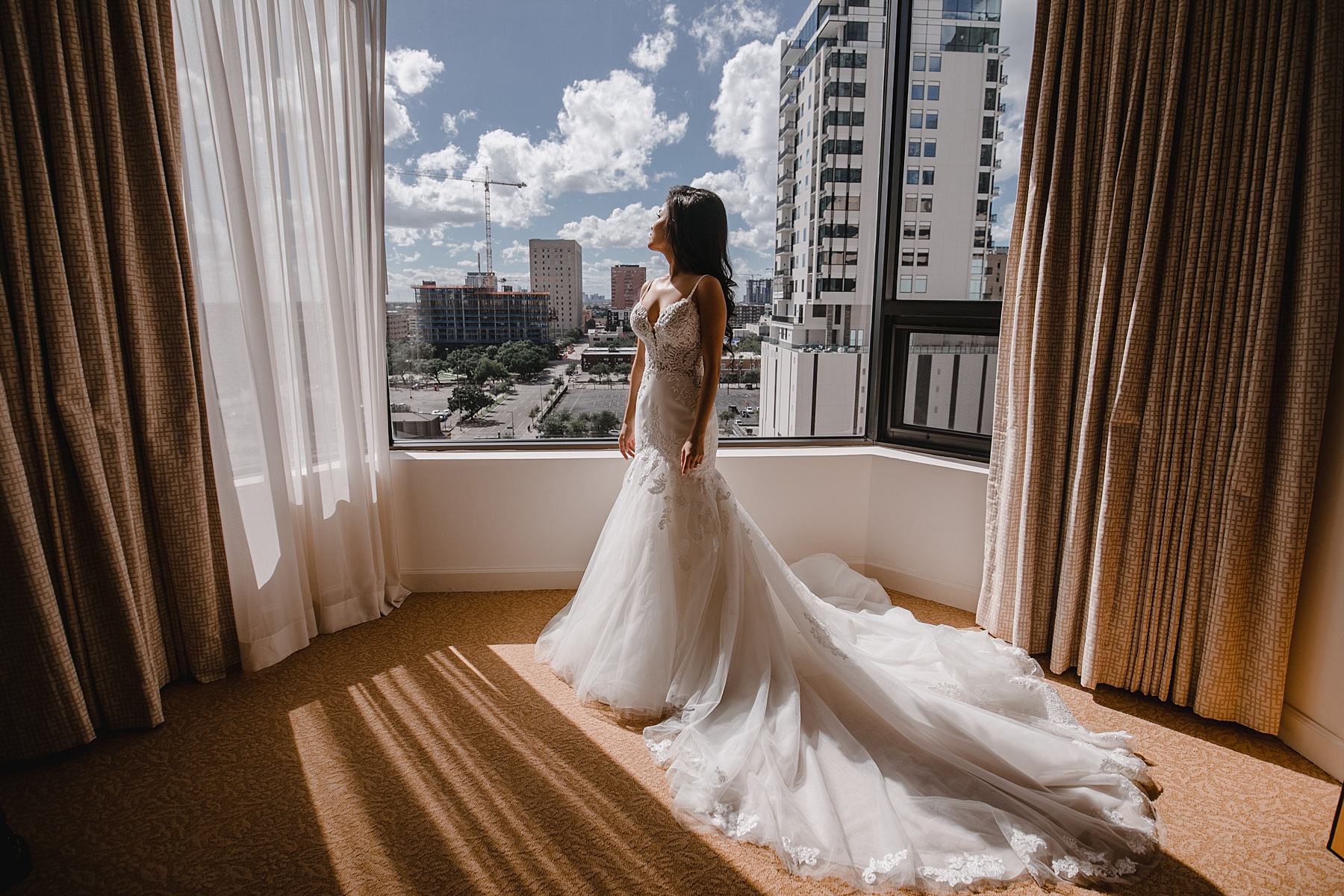 Bide in the window of her Four Seasons hotel room before her wedding reception