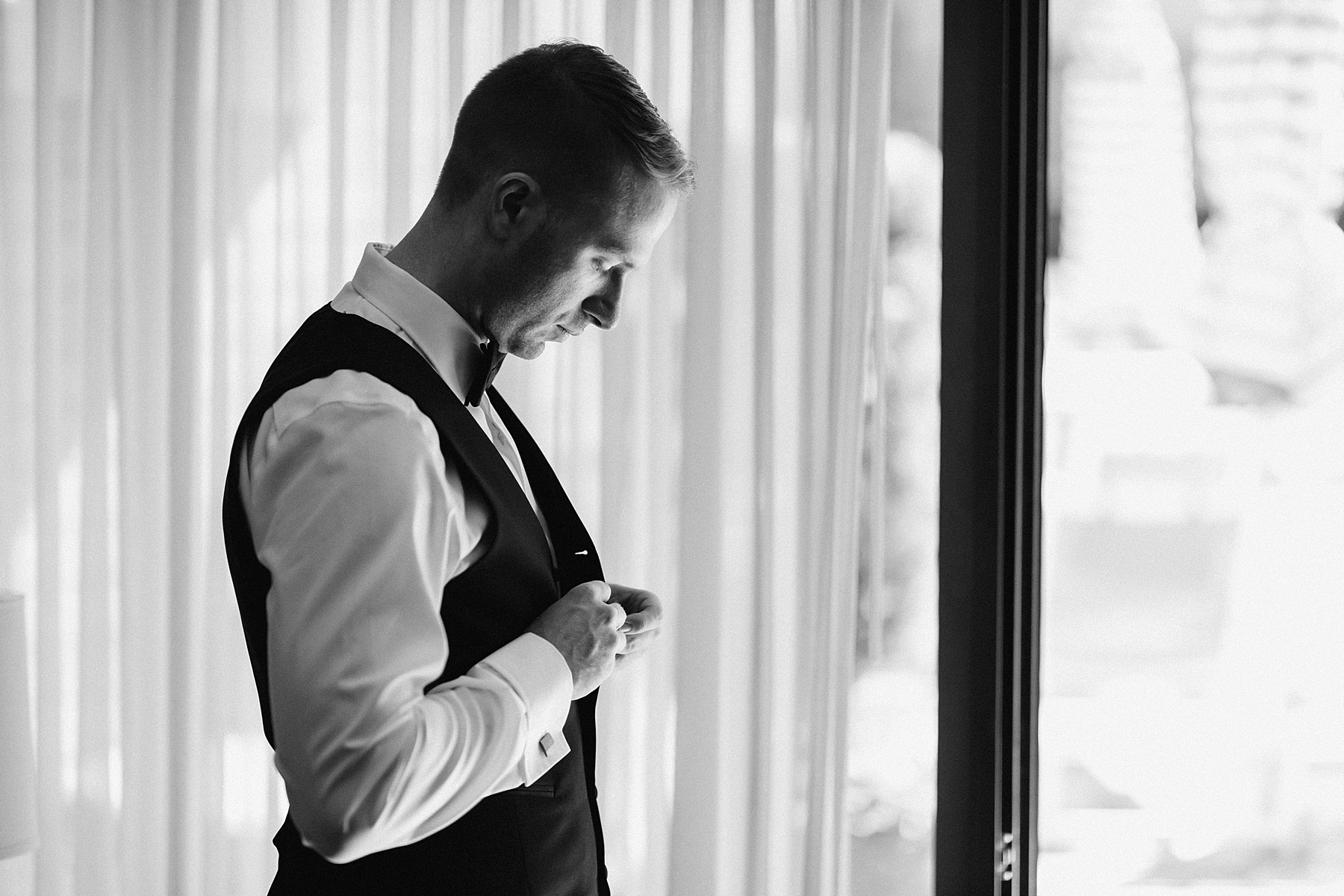 Black and white image of the Groom preparing for his wedding day