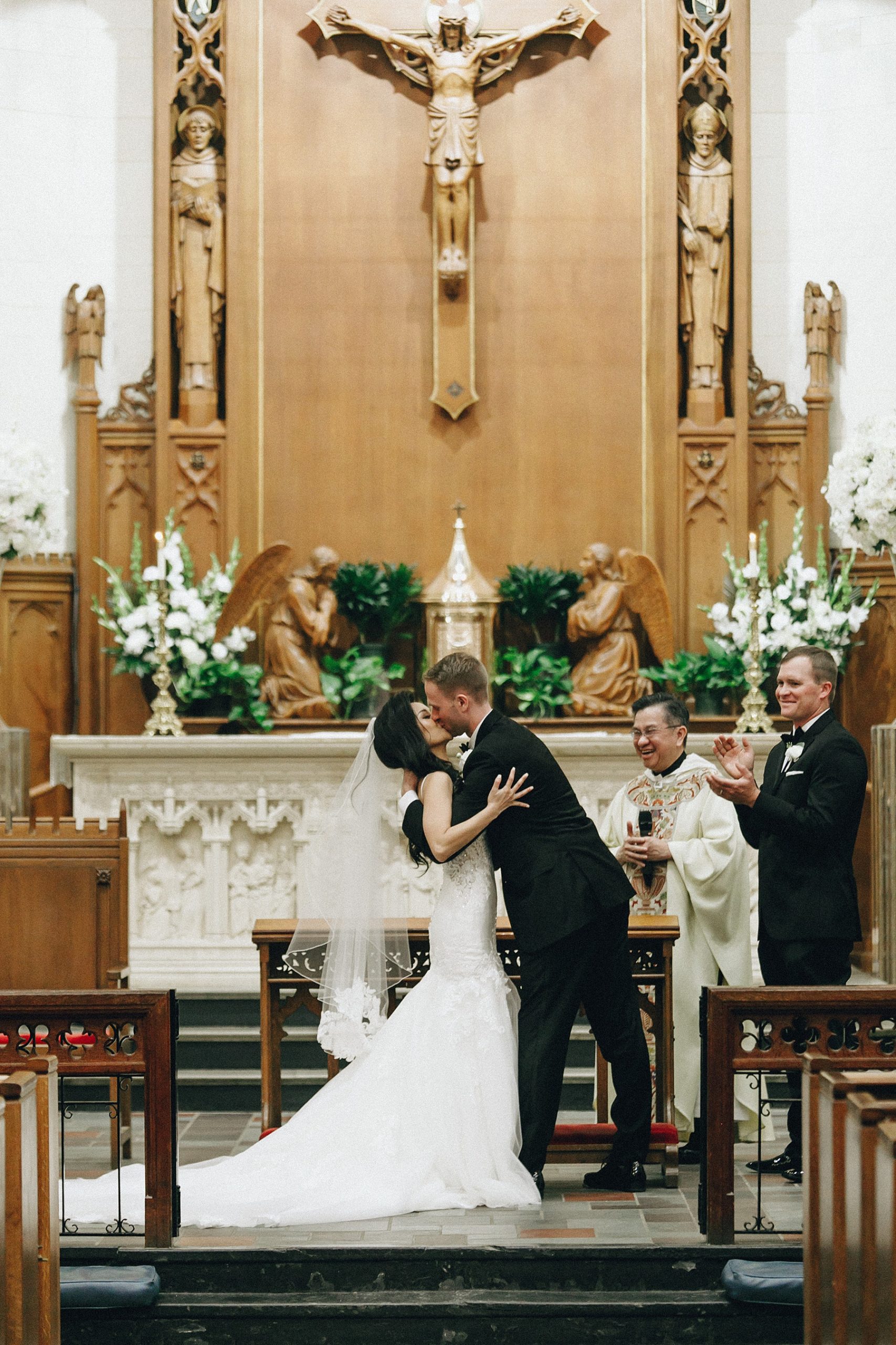 Bride and Groom kiss at the altar 