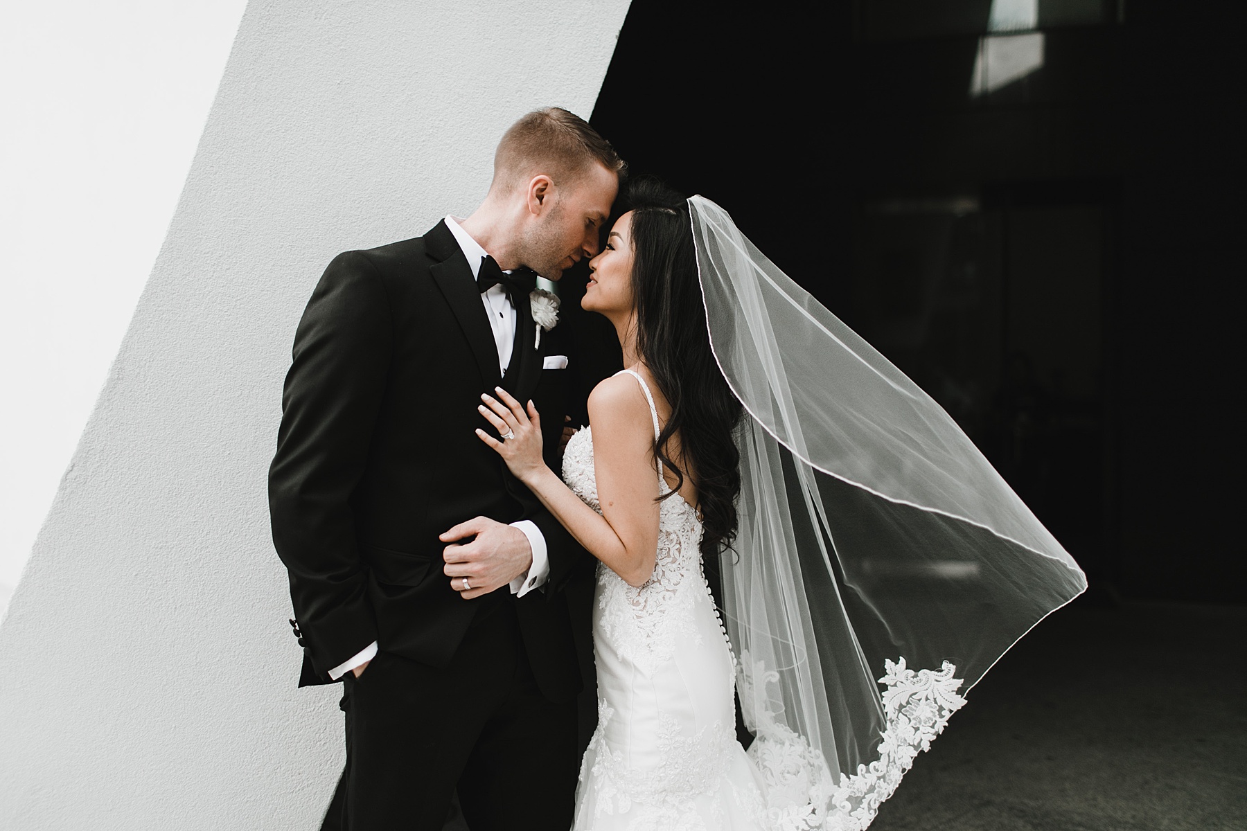 Bride and Groom portrait in front of black and white aesthetic wall in Houston