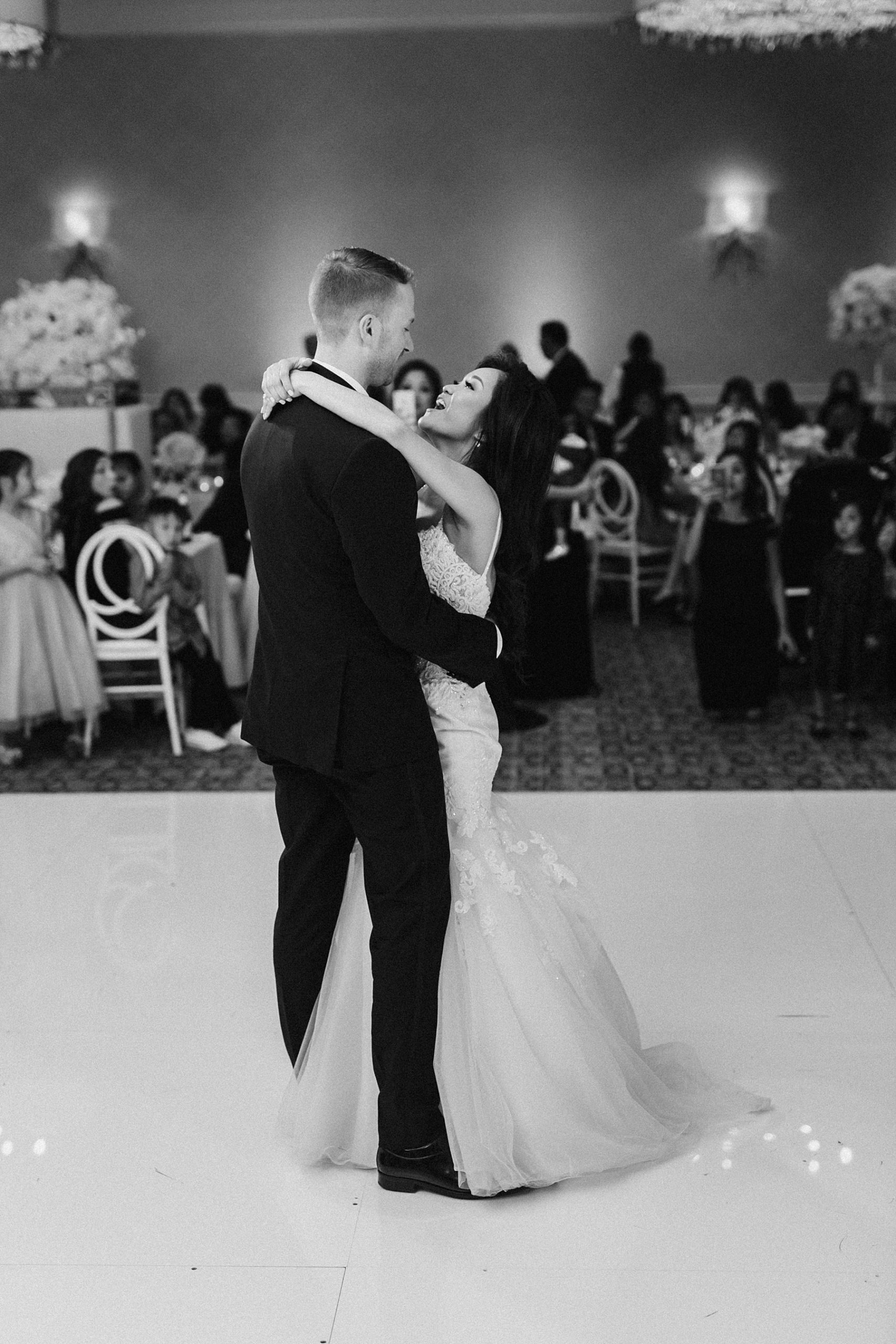 Black and white picture of the bride and groom enjoying their first dance at the Four Seasons Houston
