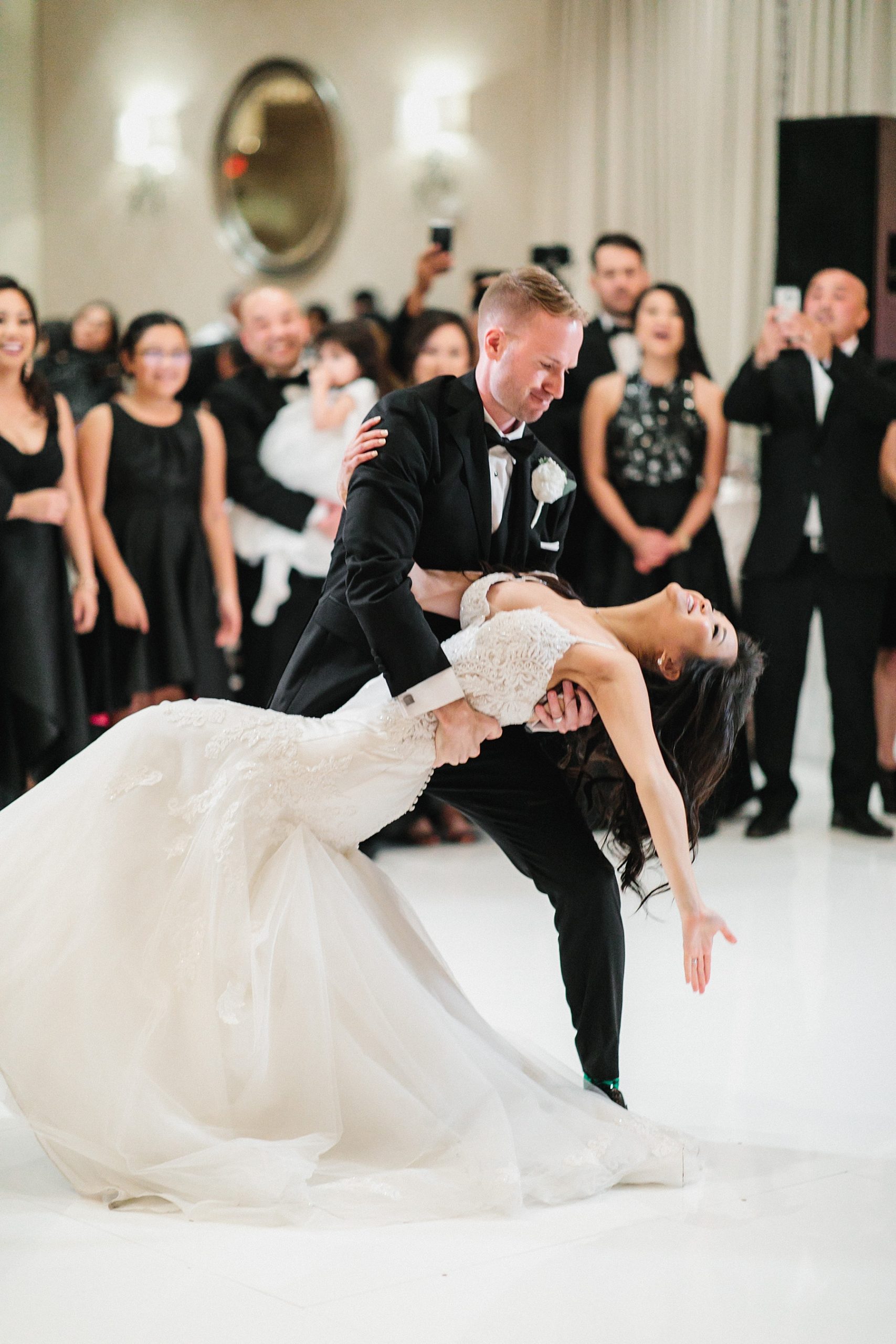 Beautiful picture of the bride and groom enjoying their first dance at the Four Seasons Houston