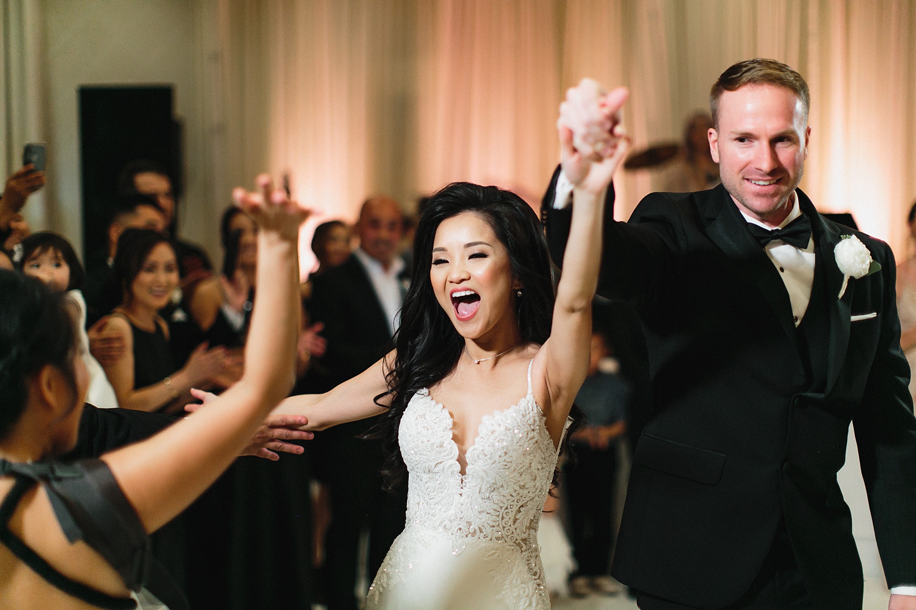 Smiles all around as the bride and groom enjoy their wedding reception at the Four Seasons Houston