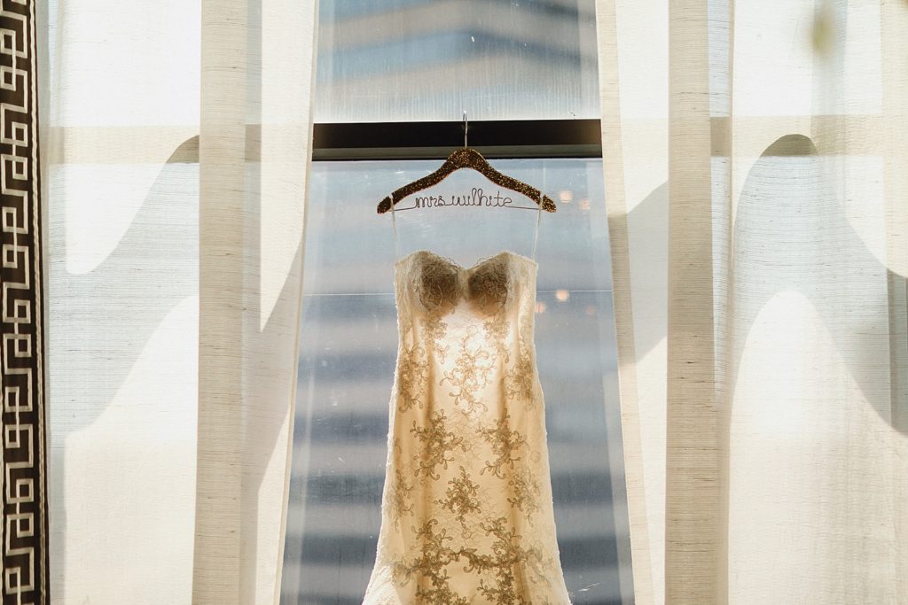wedding dress hanging in window at the omni houston