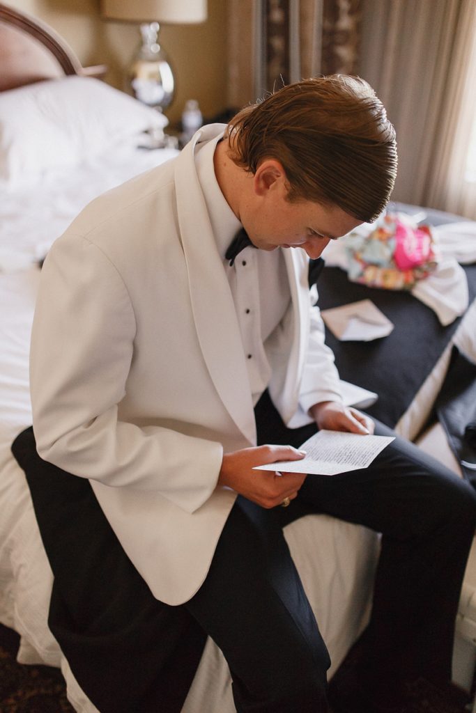groom reading letter from bride in his omni hotel room
