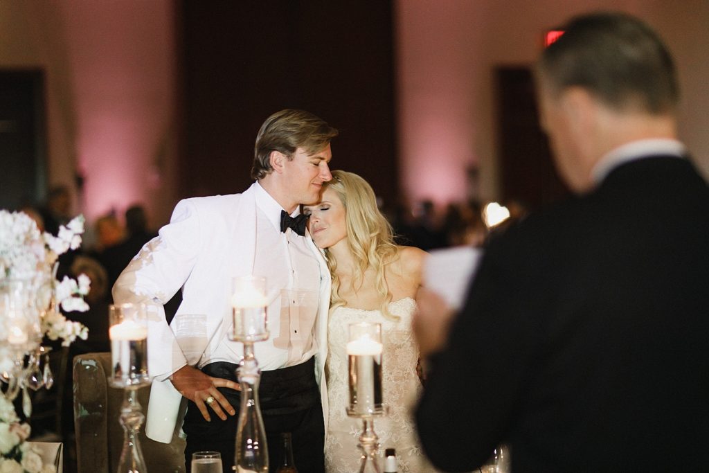 bride and groom hug during toasts at the omni hotel houston