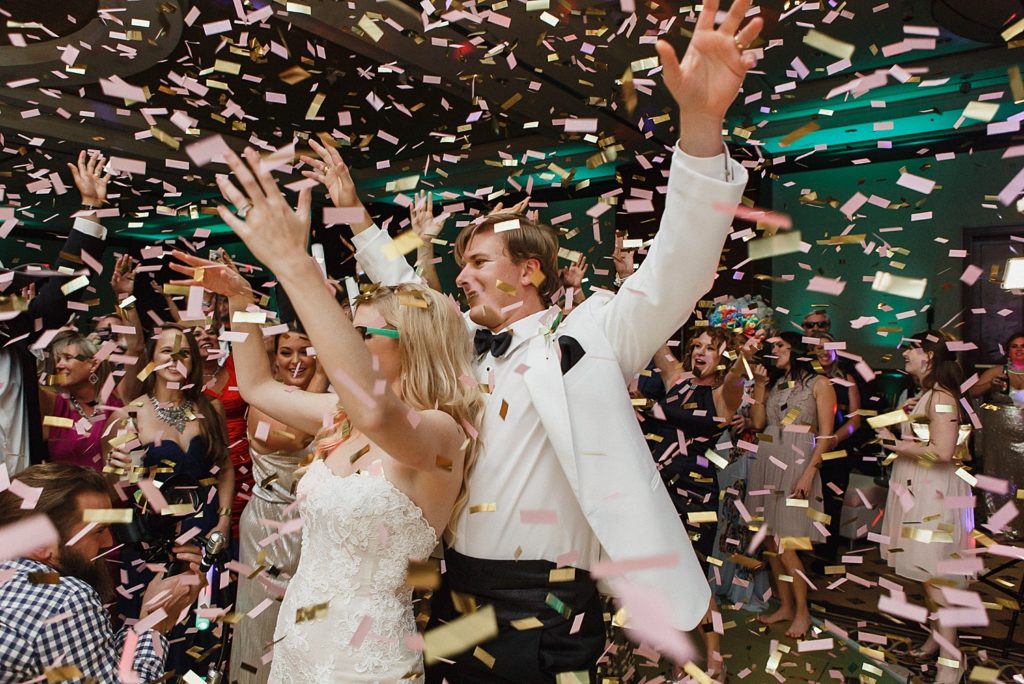 bride and groom dancing in confetti at their omni houston reception