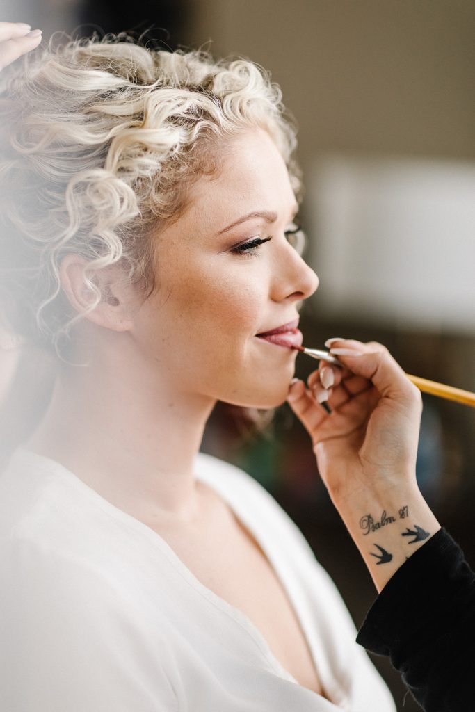 bride getting makeup done at the marquis houston