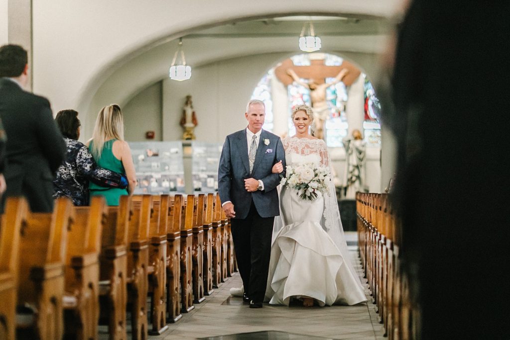 Bride walks down the aisle at church ceremony in Houston
