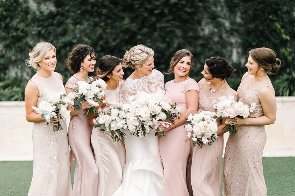 Bride and Bridesmaids smiling in group picture after huston wedding ceremony 
