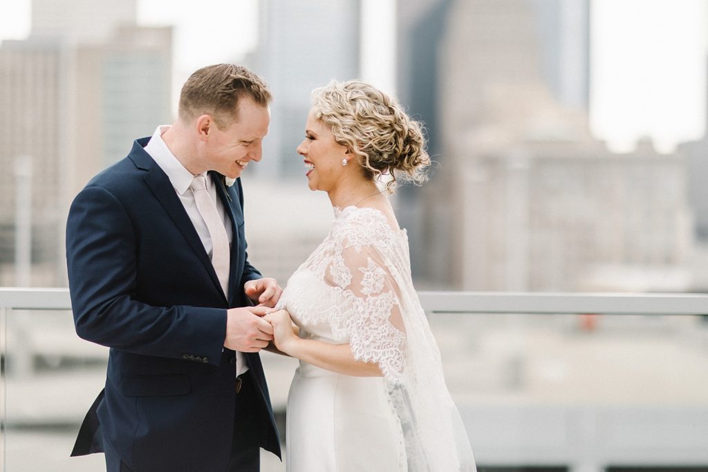 Smiling Bride and Groom in their wedding day portraits on the rooftop of The Marquis, houston
