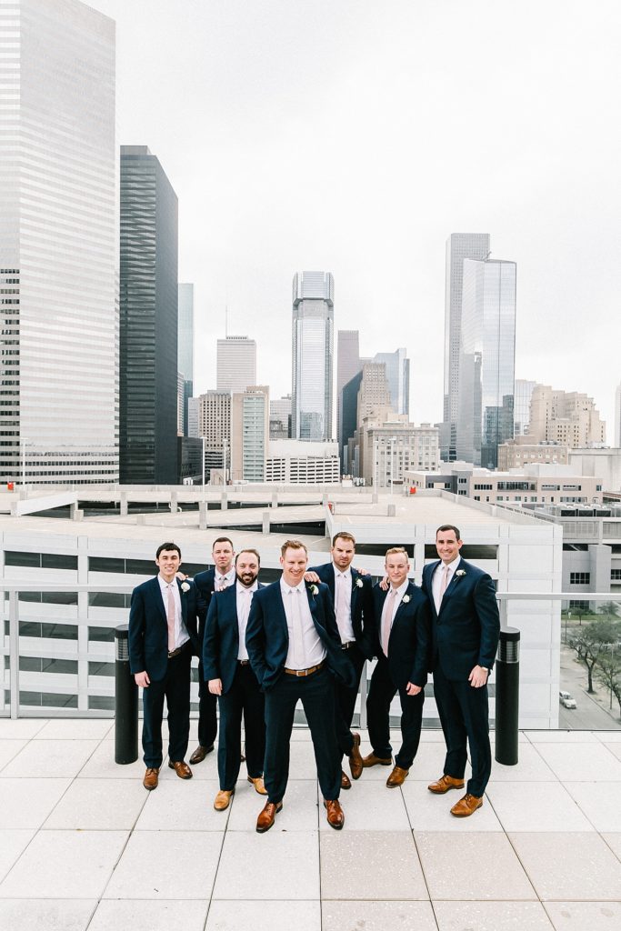 Groom and Groomsmen smiling in group picture post wedding ceremony 