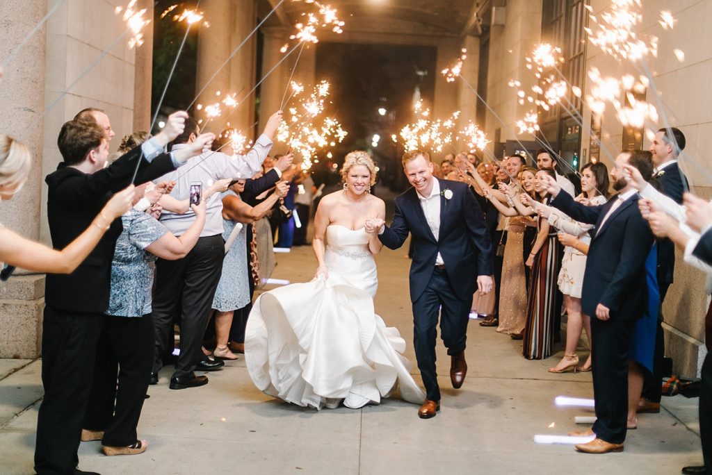 The happy couple leave their reception at The Minute Maid Park under an arch of sparklers  
